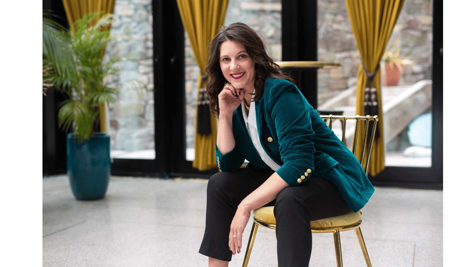 Carly Clark Zimmer seated in a teal jacket