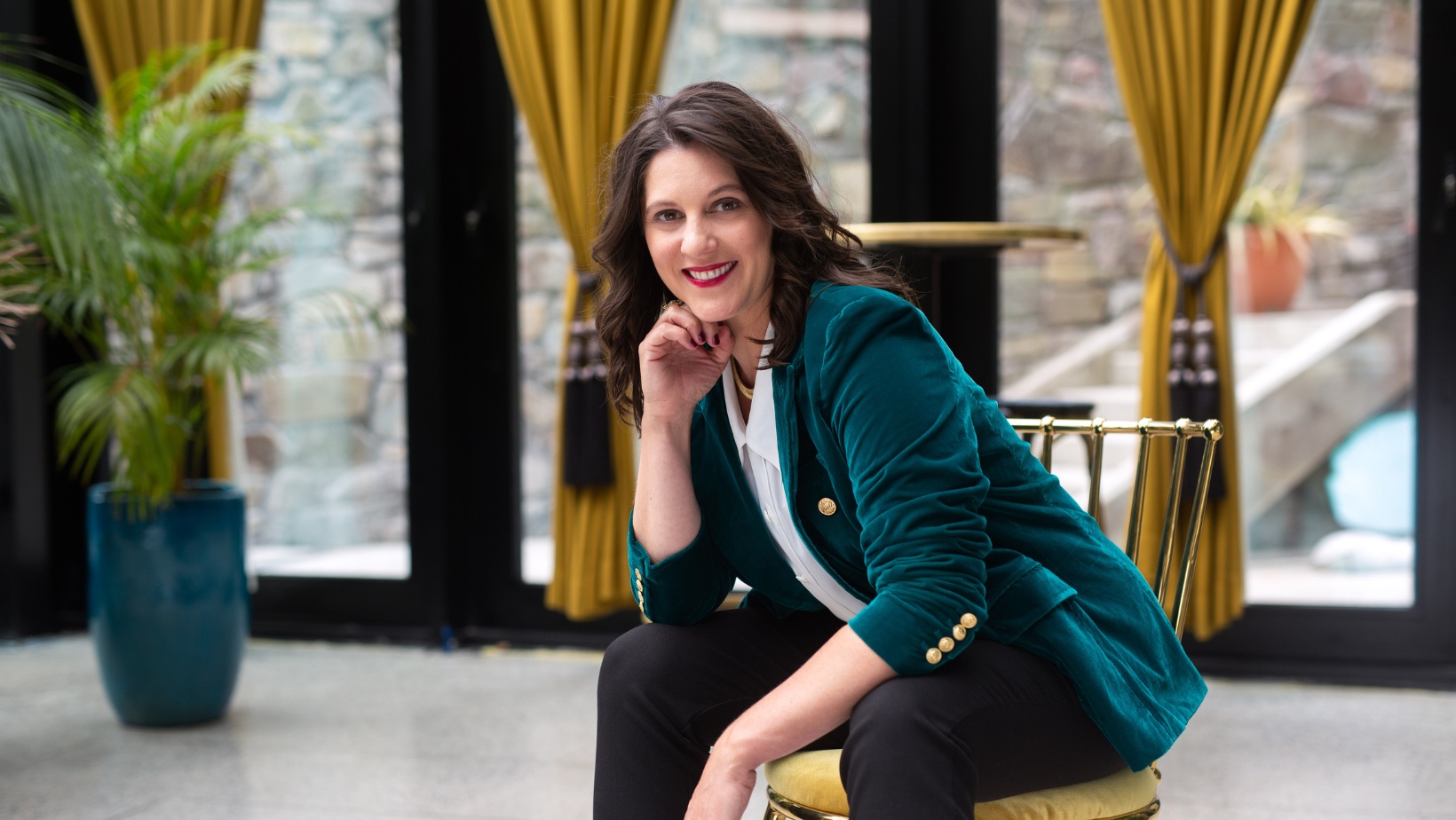 Carly Clark Zimmer seated in a teal jacket